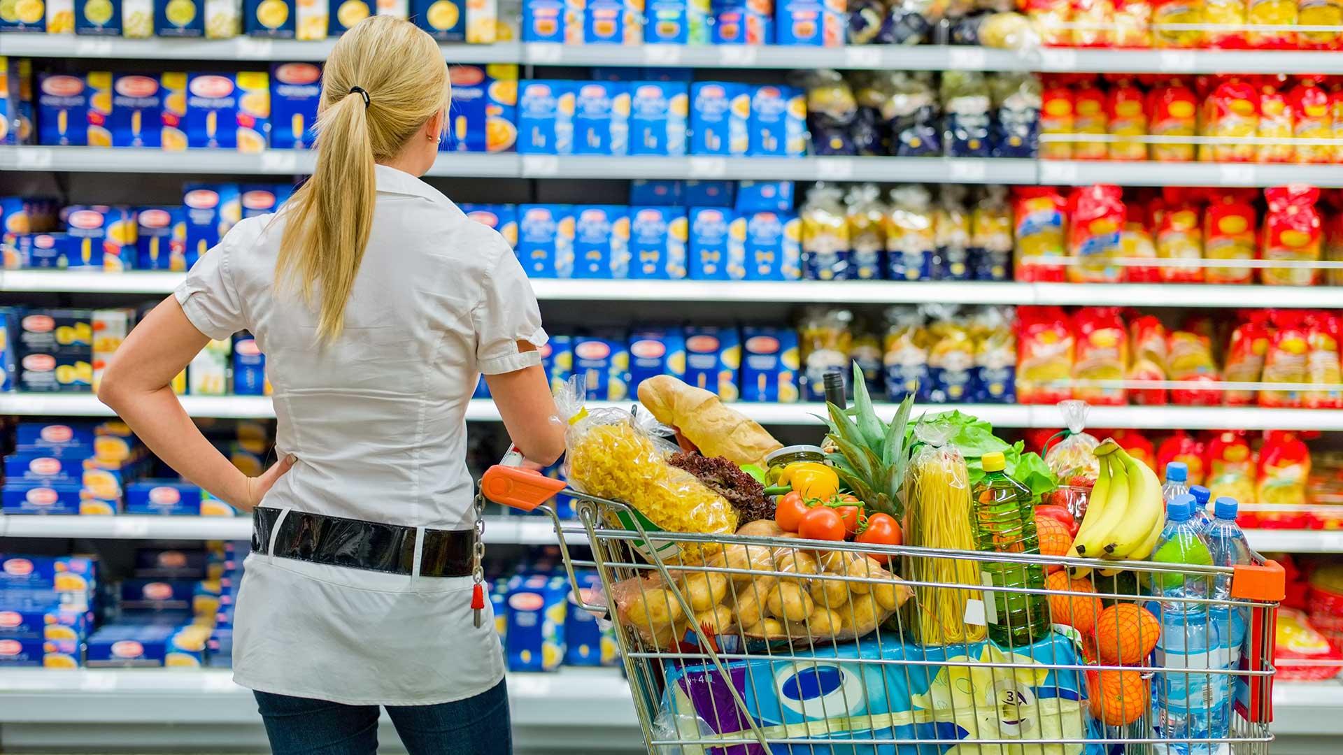 Woman standing in front of shopping isle