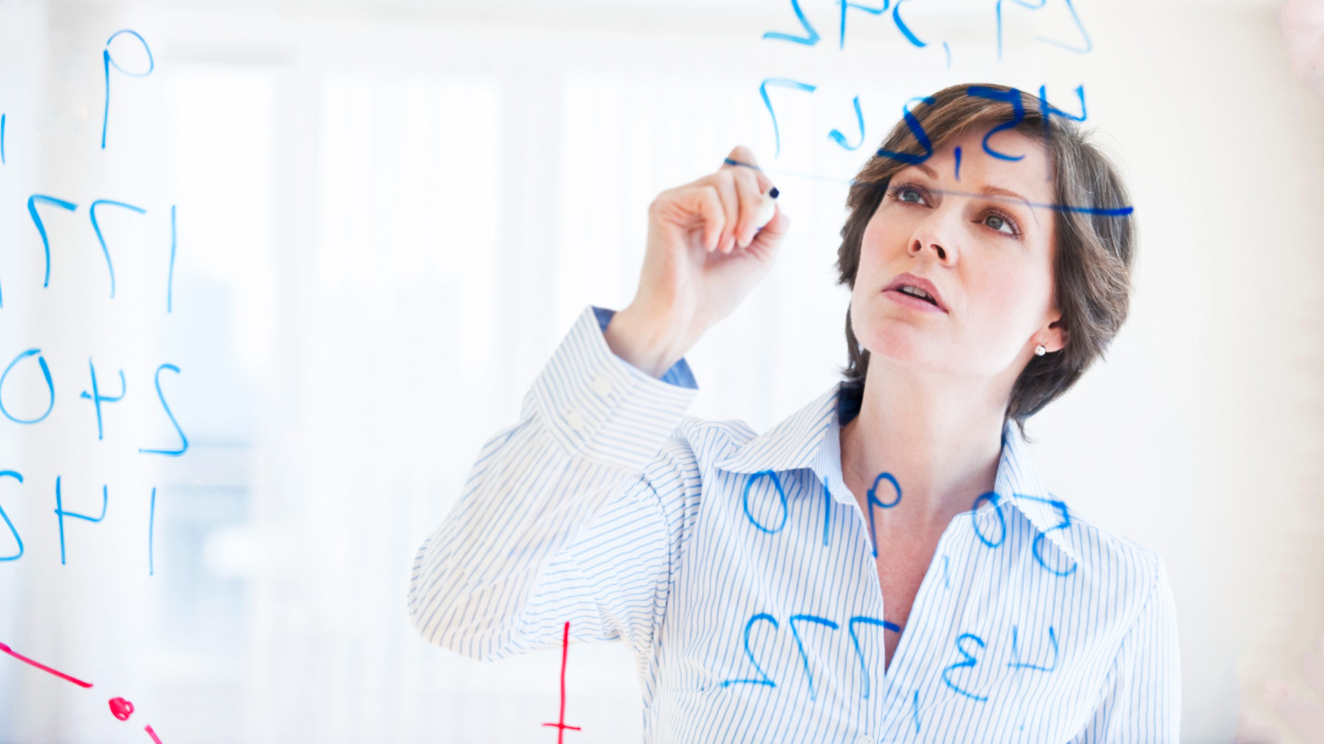 Woman drawing on glass board